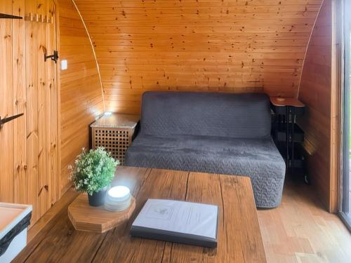 a small room with a bed and a table at Pencaerau Pods - Tudwal Pod in Pwllheli