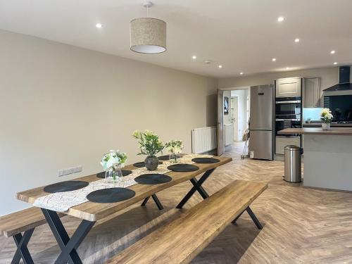 a kitchen and dining room with a table and benches at Barncroft Retreat - Uk51693 in Flimby