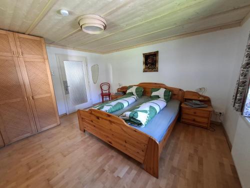 a bedroom with a large wooden bed with pillows at Haus Kern in Hallstatt
