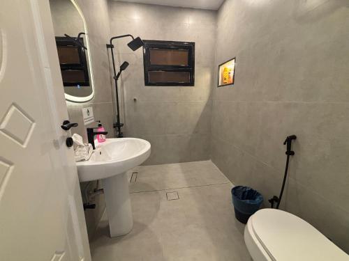 a small bathroom with a sink and a toilet at Nasaem Al Naseem in Medina