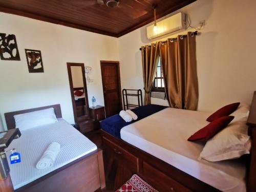 a bedroom with two beds and a window at Inpan's beach resort Batticaloa in Batticaloa