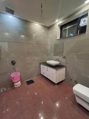 a bathroom with a sink and a toilet at Hotel Park Blu in Pānīpat