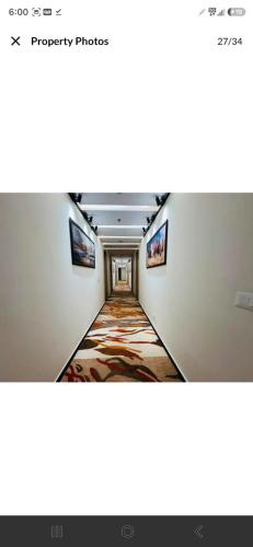 a hallway in a building with paintings on the walls at Evara Exotica in Darbhanga