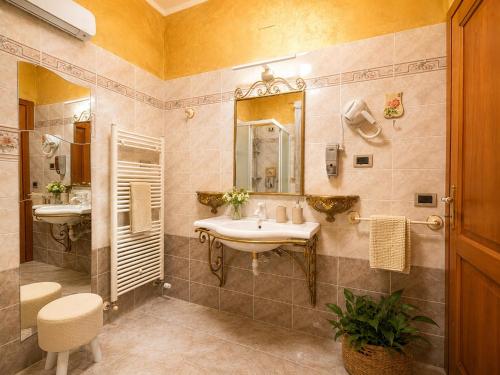 a bathroom with a sink and a mirror at La Mammola Bed&Breakfast in Fabriano