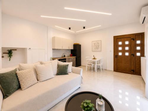 a living room with a couch and a table at Oasis Acropolis Serres Parking EV Next to Center in Serres