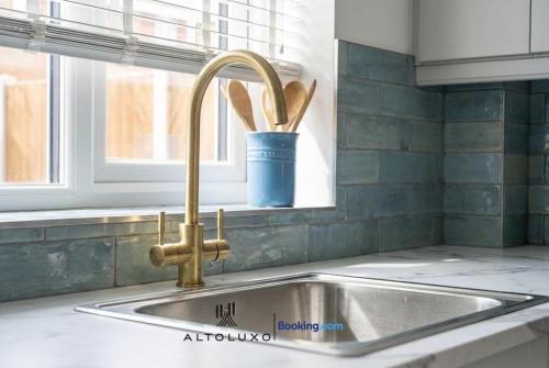 a kitchen sink with a faucet next to a window at AltoHaus Luxury 4BR House By AltoLuxo Short Lets & Serviced Accommodation With Parking in Bristol