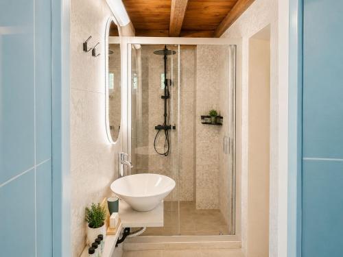 a bathroom with a sink and a shower at Petropoulakis Tower in Gythio
