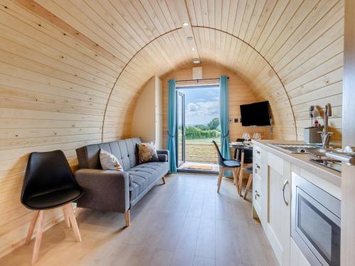 a living room with a couch and a table at Rabbits Rest - Uk46128 in Nesscliffe