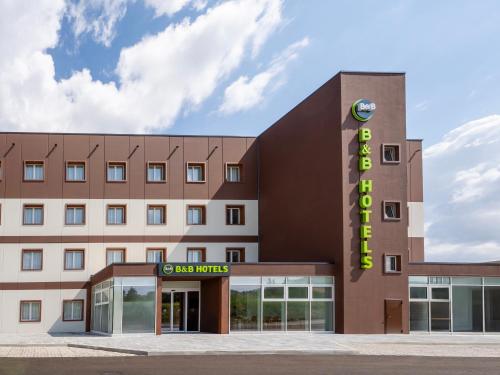 a hotel building with a sign that reads headquarters at B&B HOTEL Ascoli Piceno in Ascoli Piceno