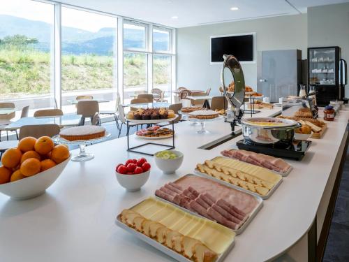 a buffet with a lot of food on a table at B&B HOTEL Ascoli Piceno in Ascoli Piceno