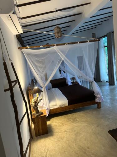 a bedroom with a bed with a mosquito net at Bethel Ella in Ella