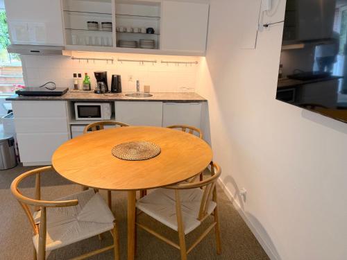a small kitchen with a wooden table and chairs at Studio Next to CPH Airport with Outdoor Space in Copenhagen