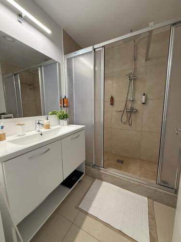 a white bathroom with a shower and a sink at Blaxy del Mar Studio Olimp in Olimp
