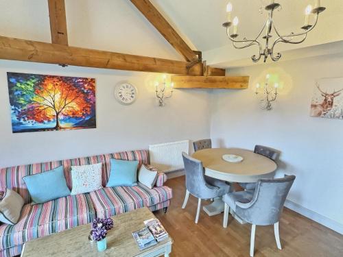 a living room with a couch and a table at Valentines Cottage - Uk48509 in Kirk Hammerton