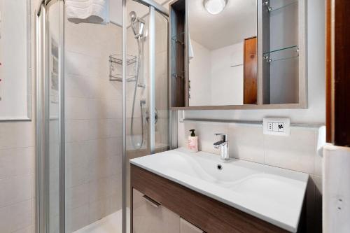 a bathroom with a sink and a shower at Dolomiti Apartment Pinzolo in Pinzolo