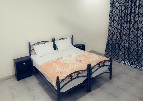 a bed with two pillows on it in a room at Zahra Suites in Elephant Island