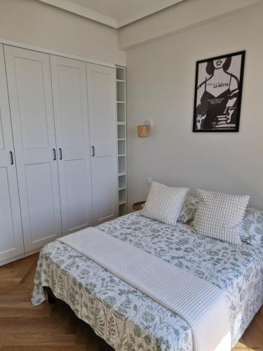 a bedroom with a bed and white cabinets at Azur Pearl - Luxury Sea View Apartement - La plage à vos pieds in Nice