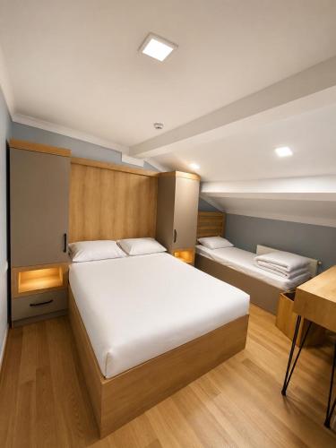 a bedroom with a large white bed and a desk at Ena Suites in Çaykara