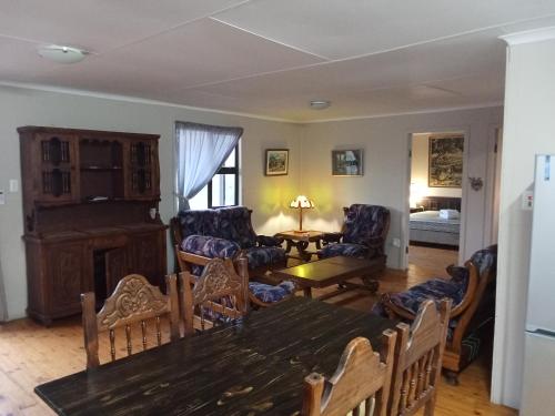 a living room with a table and chairs at Bietjierus Guest Cottage in Twee Riviere