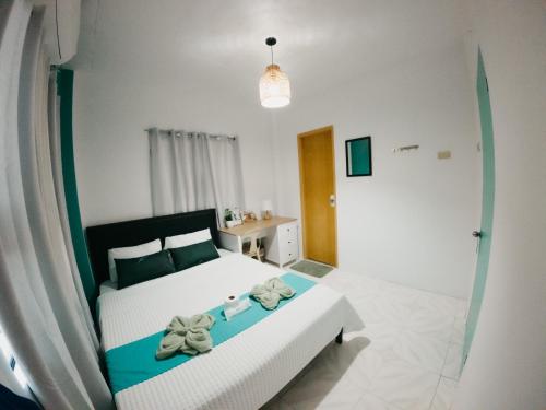 a bedroom with a bed with bows on it at New Modern Summer House in Moalboal
