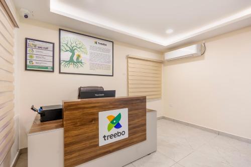 a reception desk in a room with a sign at Treebo Skanda Grande in Pondicherry