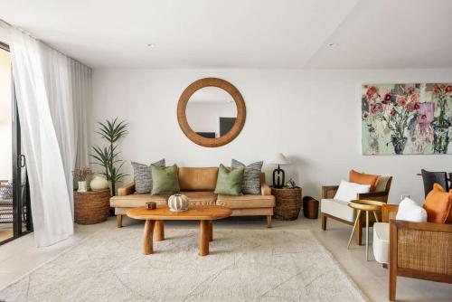 a living room with a couch and a table at Postcard on Sunrise in Sunrise Beach
