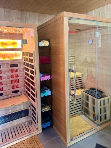 a walk in shower in a room with a closet at Sidka & Adam in Liptovský Ján