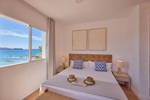 a bedroom with a bed with a view of the ocean at INNER Niza Paguera in Paguera