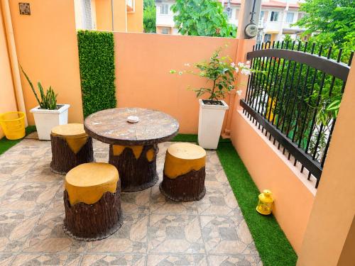 a patio with a table and stools on a balcony at Fantasia House General Santos in Lagao II