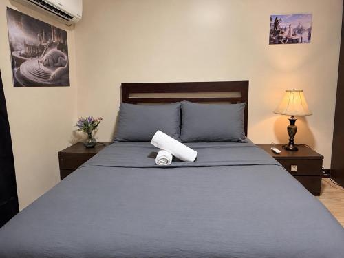 a bedroom with a blue bed with a roll on it at Fantasia House General Santos in Lagao II