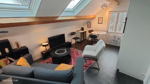 a living room with a couch and a table at WhiteHouse Lozère in Palaiseau