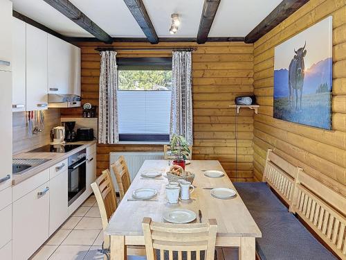 a kitchen with a table and chairs in a room at Apartment Franzi 2 by Interhome in Arrach