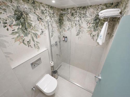 a bathroom with a shower and a toilet in it at Ovva Inn Yeşilovacık Hotel in Dibekli