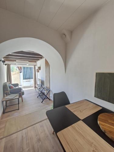 a bedroom with a bed and a living room at La Voûte - Clim et Gare 5 min in Rumilly
