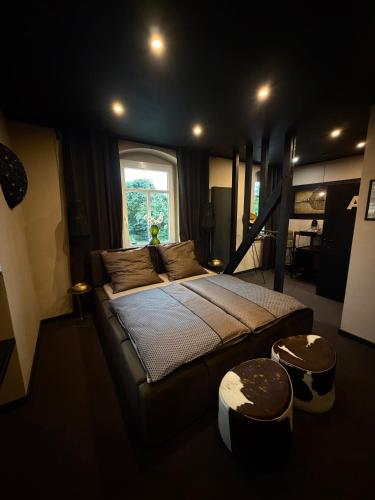 a bedroom with a large bed and a window at 4 Rooms Pixel A in Herzebrock