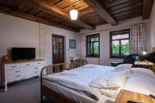a bedroom with a large bed and a television at Chalupa MATEJKO in Liptovský Mikuláš
