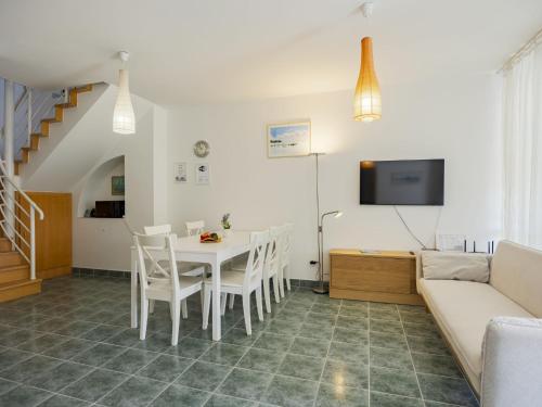 a living room with a table and chairs and a couch at Apartment Pamela by Interhome in Balatonőszöd