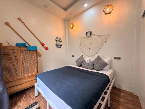 a bedroom with a bed and baseball bats on the wall at Rumah Kodel2 in Bukit Lawang