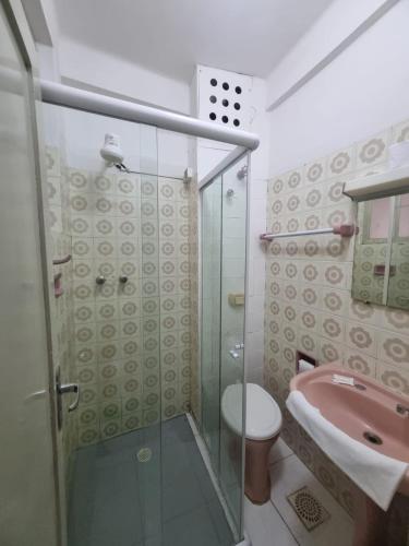 a bathroom with a shower and a toilet and a sink at Grande Hotel Torres in Torres
