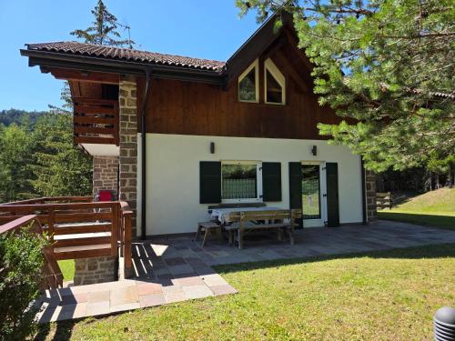 a small house with a patio in front of it at Chalet Villa Bianca in Tesero