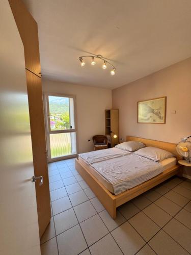 a bedroom with a large bed and a window at Lago Blu in Riva del Garda