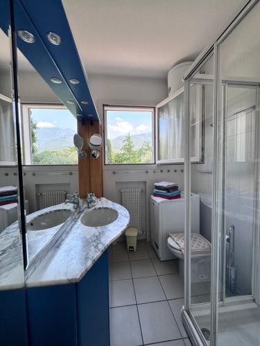 a bathroom with a double sink and a shower at Lago Blu in Riva del Garda