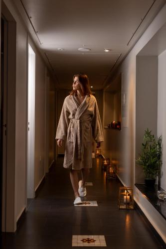 a woman is walking down a hallway at Idou Anfa Hôtel & Spa in Casablanca
