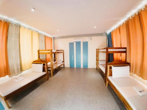 a room with four bunk beds and a hallway at Balud White Beach Resort in Moalboal