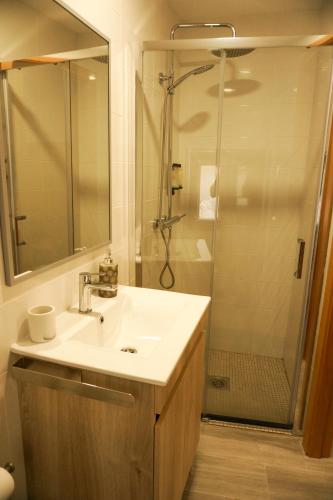 a bathroom with a sink and a shower at VIELA Guest House T1 in Barcelos