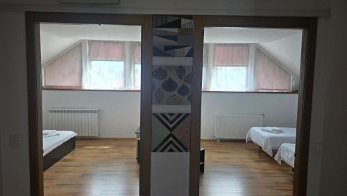 an open door to a room with two beds at Casa Cristal in Eforie Sud