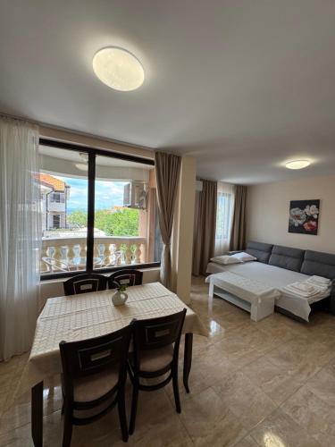a living room with a couch and a table at Luxury Apartments Ekaterina in Chernomorets