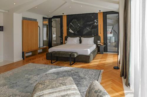 a bedroom with a large bed and a couch at CITADEL Heritage Hotel Berat in Berat