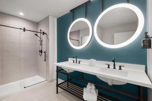 a bathroom with a sink and a mirror at Hotel Indigo Tallahassee - Collegetown by IHG in Tallahassee