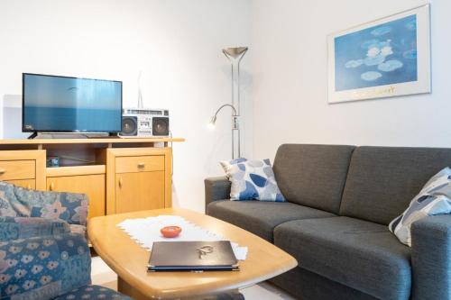 a living room with a couch and a table at Haus Roland, Wohnung 03 in Zinnowitz